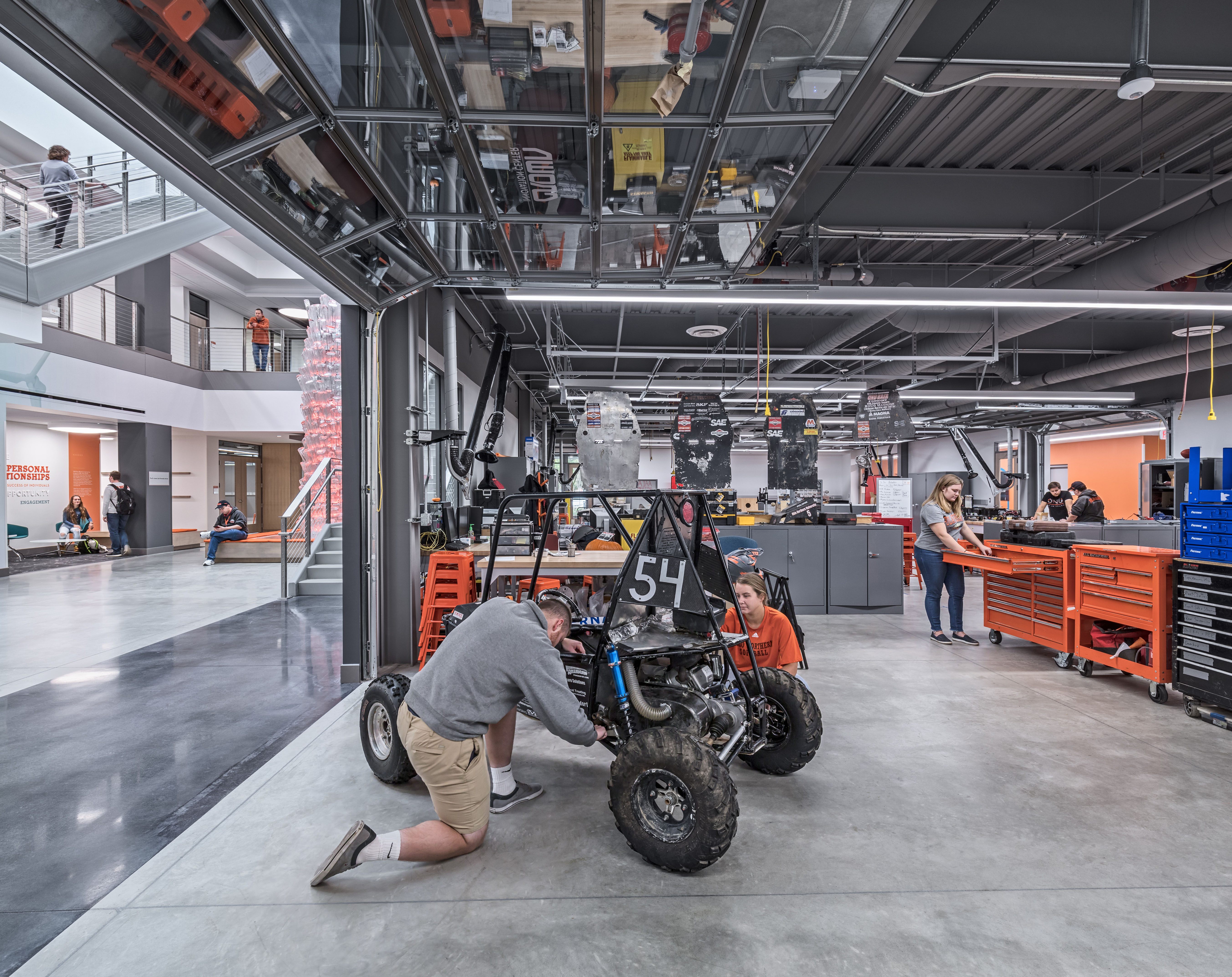 Moveable garage doors inside student studios allow visibility into the atrium 